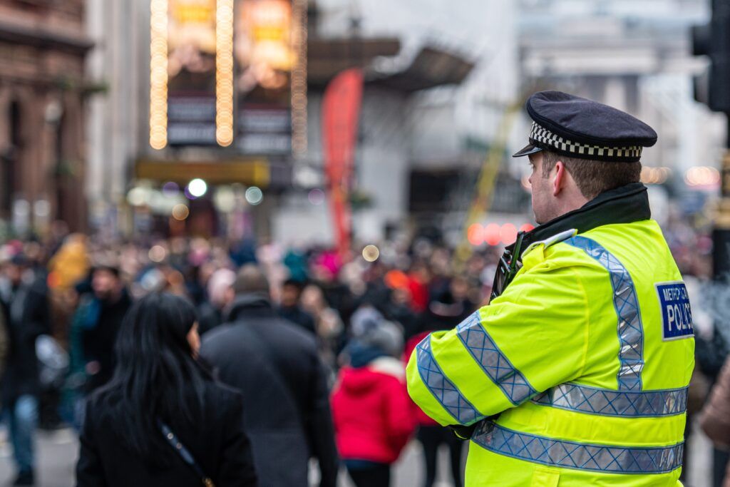 Police officer monitoring a large public crowd during Caribana, highlighting marijuana possession laws in Toronto.
