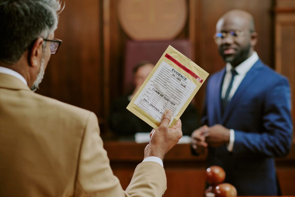 Defence lawyer presenting an evidence envelope in court during a guilty plea proceeding for a criminal offence.
