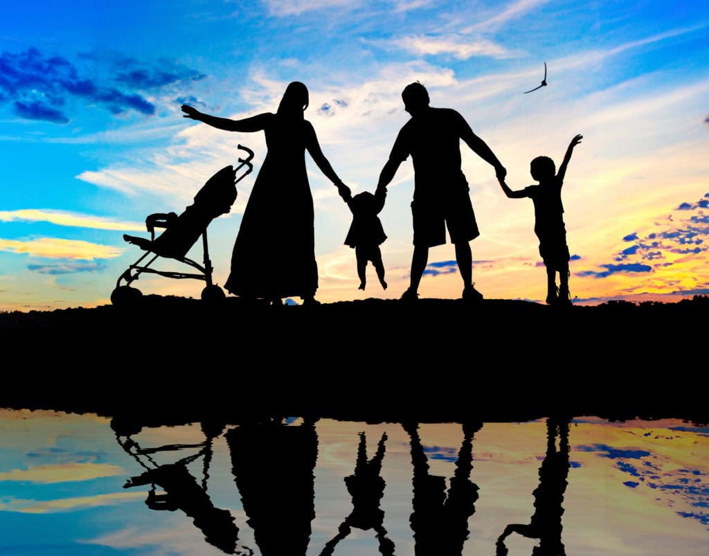Family at sunset silhouettes