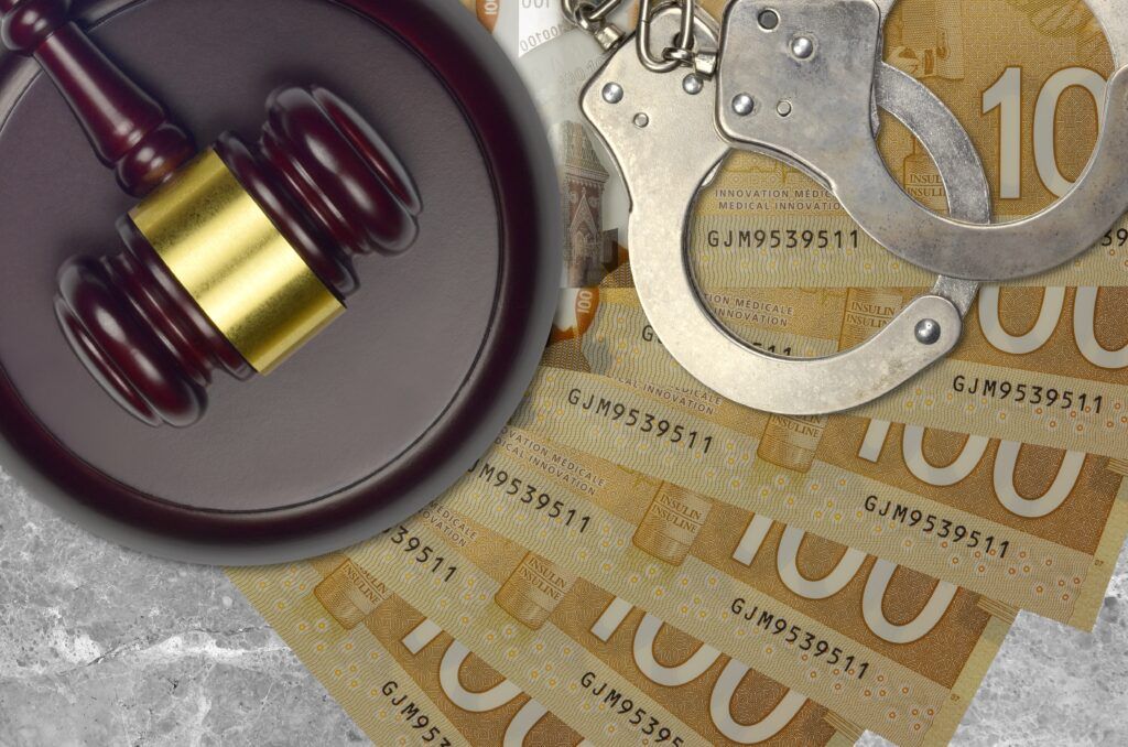 Gavel and handcuffs on Canadian banknotes, symbolizing bail hearings, surety obligations, and release conditions in Canada.