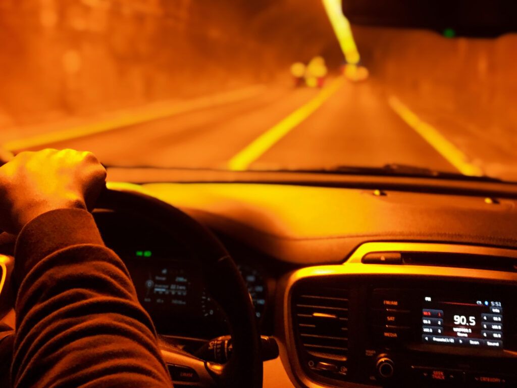 Driver operating a vehicle inside a tunnel at night, highlighting the risks of impaired driving under Canadian law